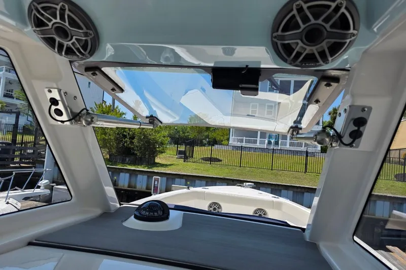 Slide: The Image of Interior view of 2023 Solace 32CS boat, featuring speakers and a compass. - 18