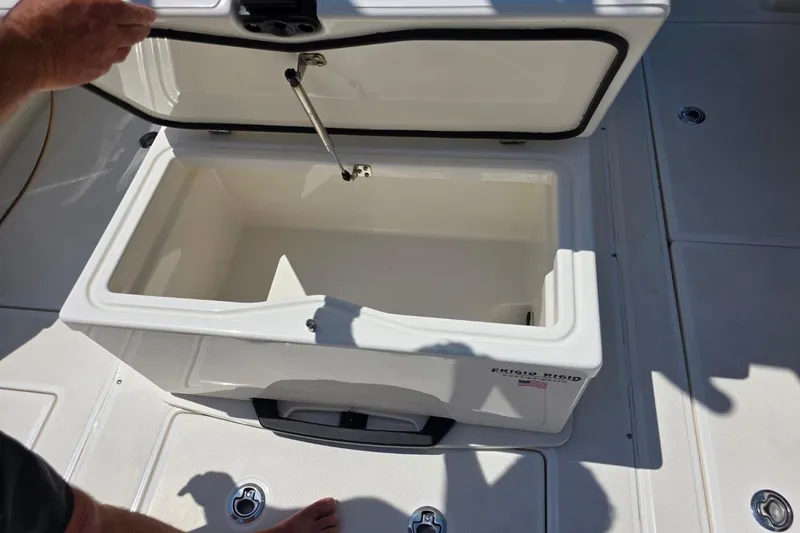 Slide: The Image of Open storage compartment on 2023 Solace 32CS boat deck. - 16