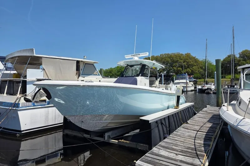 The Image of 2023 Solace 32CS boat docked at marina under clear blue sky. - 0