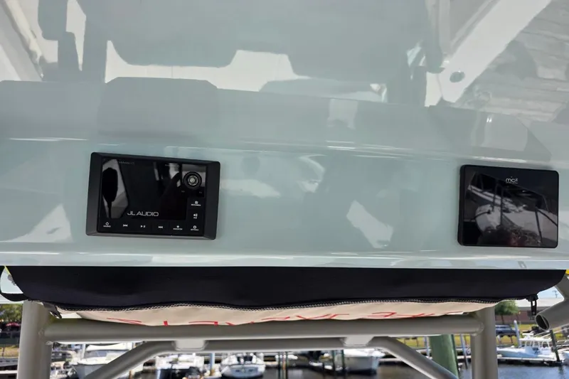 Slide: The Image of 2023 Solace 32CS boat dashboard featuring JL Audio and MCI control panels. - 14