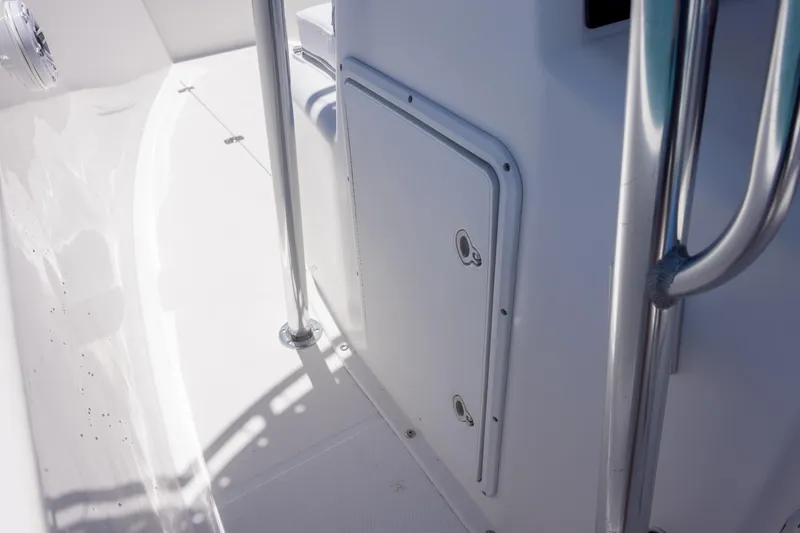 Slide: The Image of 2006 Bluewater 2150 CC boat interior with storage compartment and stainless steel railing. - 35