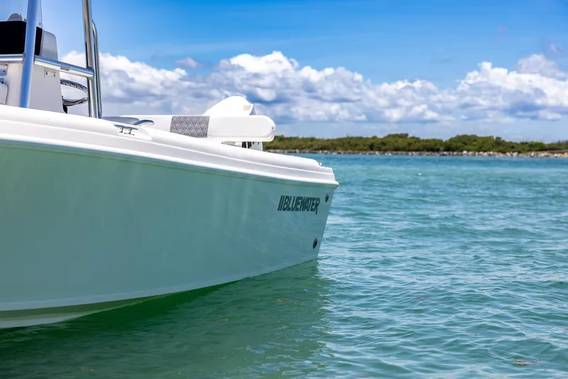 Slide: The Image of 2006 Bluewater 2150 CC boat on calm water under a blue sky. - 11