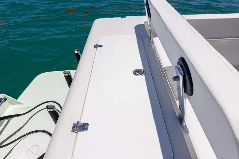 Slide: The Image of 2006 Bluewater 2150 CC boat deck with white seating and ocean backdrop. - 27