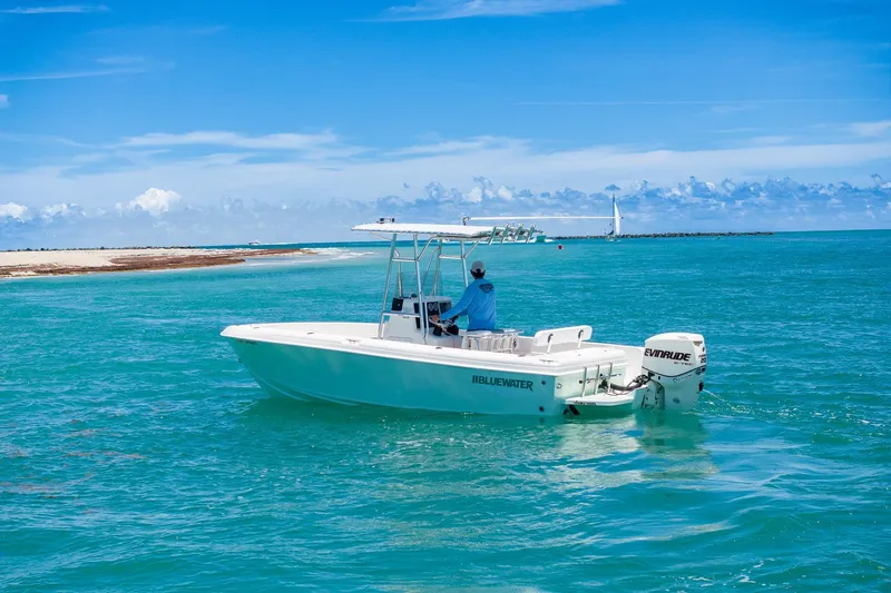 Slide: The Image of 2006 Bluewater 2150 CC boat cruising in clear turquoise waters under a bright blue sky. - 4
