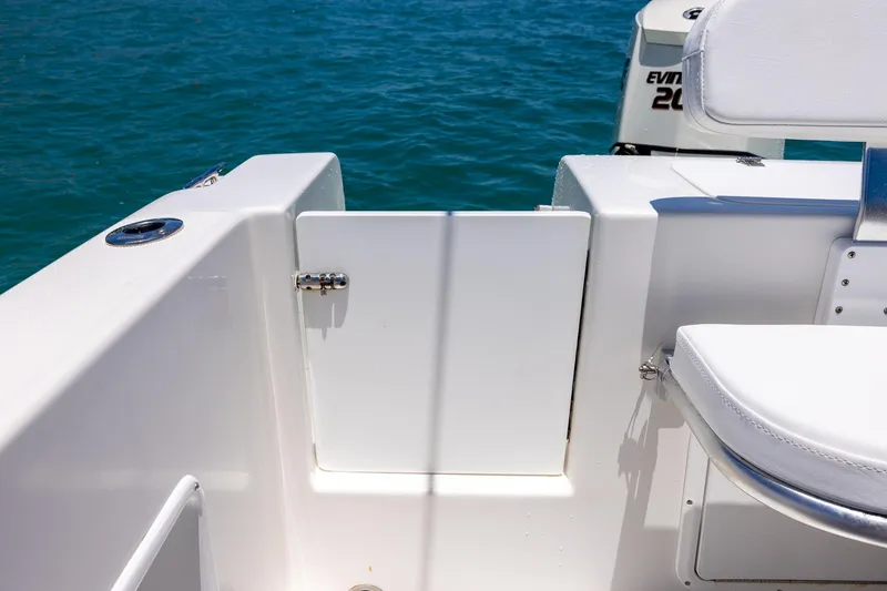 Slide: The Image of 2006 Bluewater 2150 CC boat interior with white seating and ocean backdrop. - 25