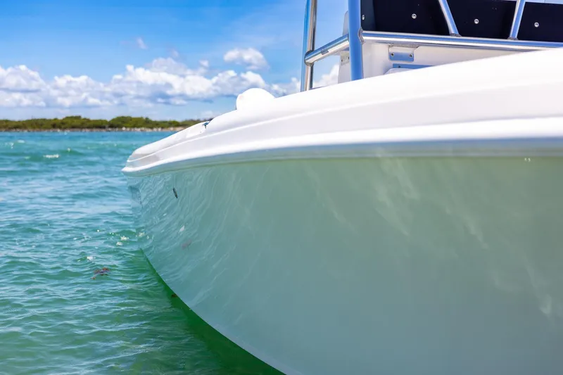 Slide: The Image of 2006 Bluewater 2150 CC boat on clear turquoise water under blue sky. - 12