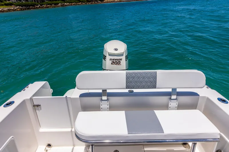 Slide: The Image of 2006 Bluewater 2150 CC boat with Evinrude 200 HP engine on blue water. - 17