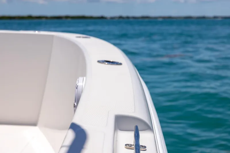 Slide: The Image of 2006 Bluewater 2150 CC boat on clear blue water, close-up view. - 34