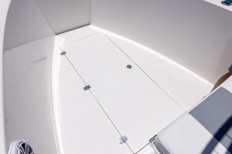 Slide: The Image of 2006 Bluewater 2150 CC boat interior with storage compartment and seating. - 36
