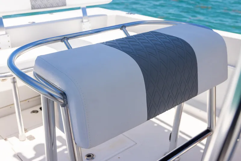 Slide: The Image of 2006 Bluewater 2150 CC boat seat with stainless steel frame and diamond-patterned upholstery. - 24