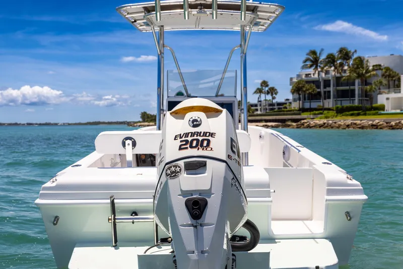 Slide: The Image of 2006 Bluewater 2150 CC boat with Evinrude 200 HP engine on clear blue water. - 15