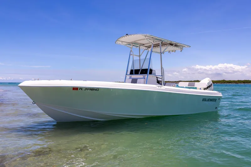 Slide: The Image of 2006 Bluewater 2150 CC boat on clear water under a bright blue sky. - 9