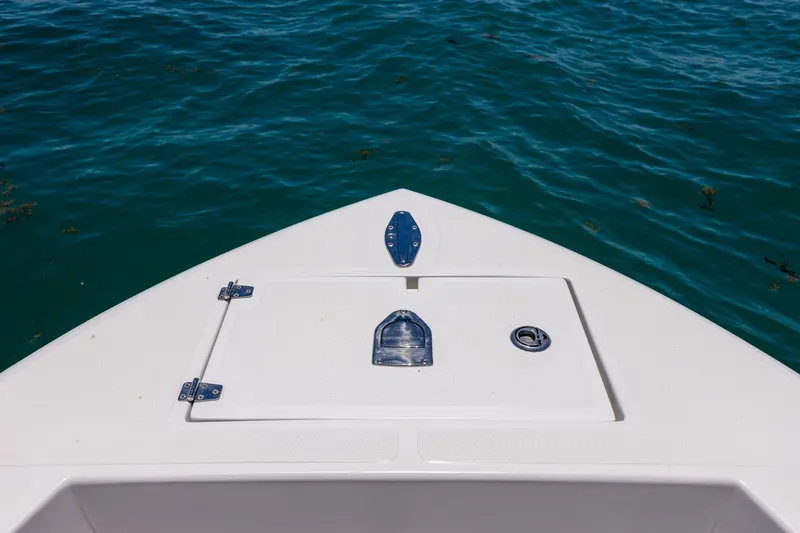 Slide: The Image of Bow of 2006 Bluewater 2150 CC boat on clear blue water. - 31