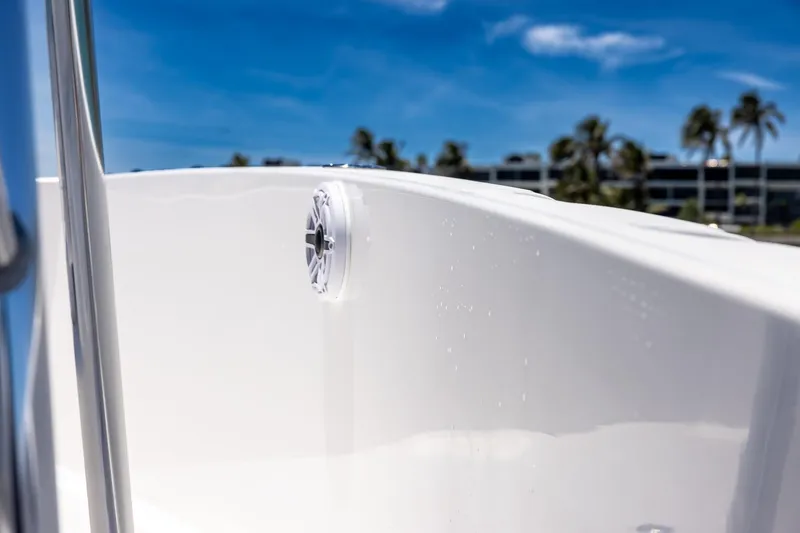 Slide: The Image of 2006 Bluewater 2150 CC boat detail with speaker, clear sky background. - 21