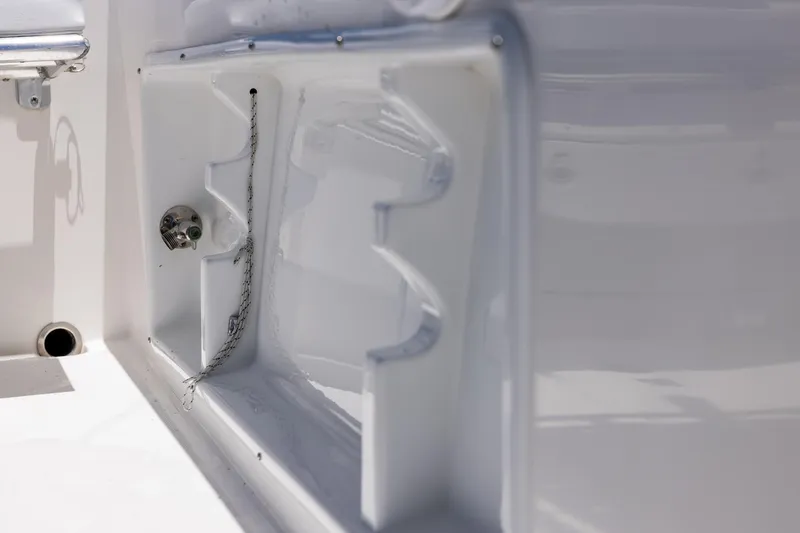 Slide: The Image of Close-up of 2006 Bluewater 2150 CC boat interior detail, showcasing storage compartment. - 32