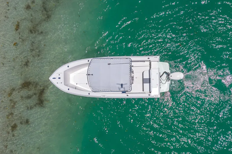 Slide: The Image of Aerial view of 2006 Bluewater 2150 CC boat on clear turquoise water. - 10