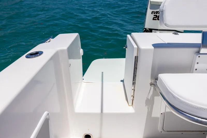 Slide: The Image of 2006 Bluewater 2150 CC boat interior with seating, near blue ocean water. - 26