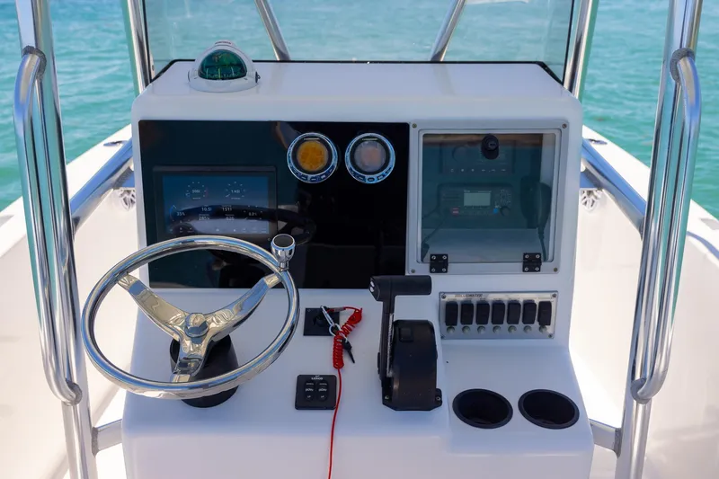Slide: The Image of Steering console of a 2006 Bluewater 2150 CC boat with navigational controls. - 18