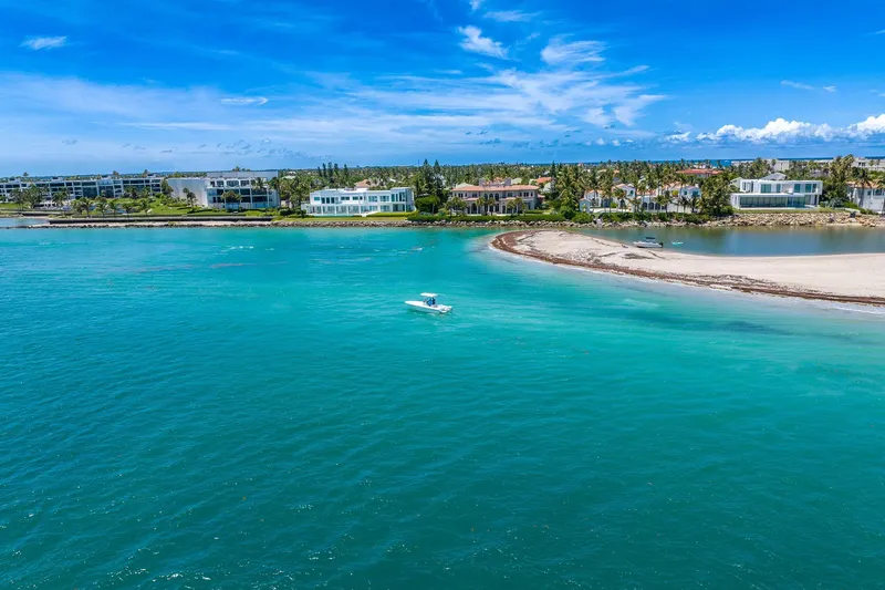 Slide: The Image of Aerial view of a 2006 Bluewater 2150 CC boat on turquoise waters near a sandy shoreline. - 7
