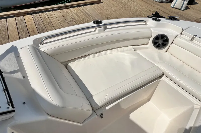 Slide: The Image of 2021 Grady-White Freedom 215 boat interior with white cushioned seating and speaker. - 25