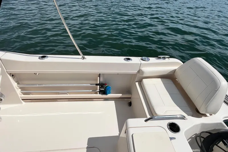 Slide: The Image of 2021 Grady-White Freedom 215 boat interior with seating, on calm water. - 11