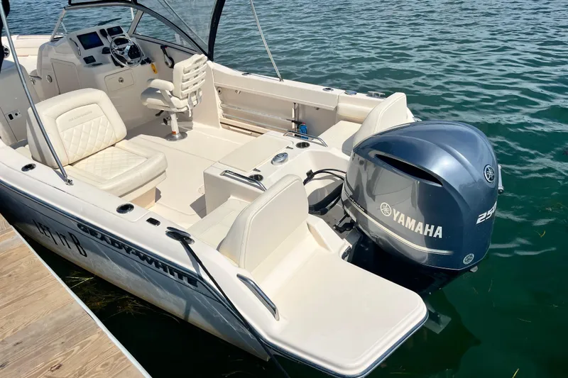 Slide: The Image of 2021 Grady-White Freedom 215 boat with Yamaha engine, docked on calm water. - 8