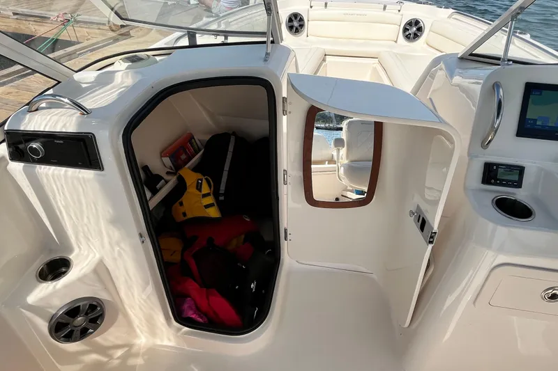 Slide: The Image of 2021 Grady-White Freedom 215 boat interior with storage compartment and seating area. - 21