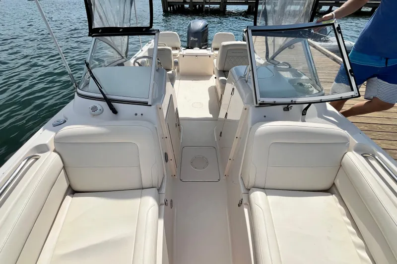 Slide: The Image of 2021 Grady-White Freedom 215 boat interior with seating and open windshield on the water. - 30
