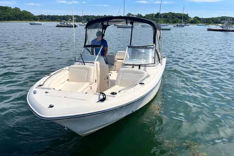 Slide: The Image of 2021 Grady-White Freedom 215 boat on calm water, featuring a sleek design and canopy. - 3