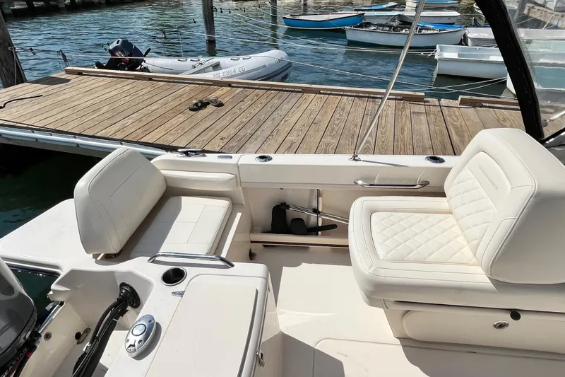 Slide: The Image of 2021 Grady-White Freedom 215 boat interior with white seating at dock. - 12
