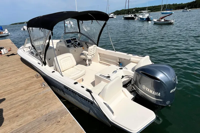 Slide: The Image of 2021 Grady-White Freedom 215 boat docked with Yamaha engine, calm water background. - 7