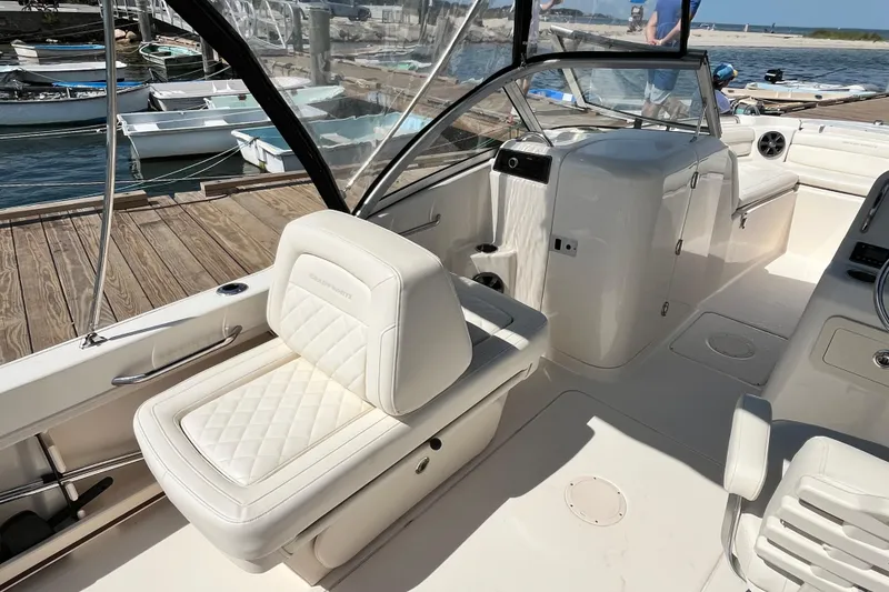 Slide: The Image of 2021 Grady-White Freedom 215 boat interior with white seating at a dock. - 13