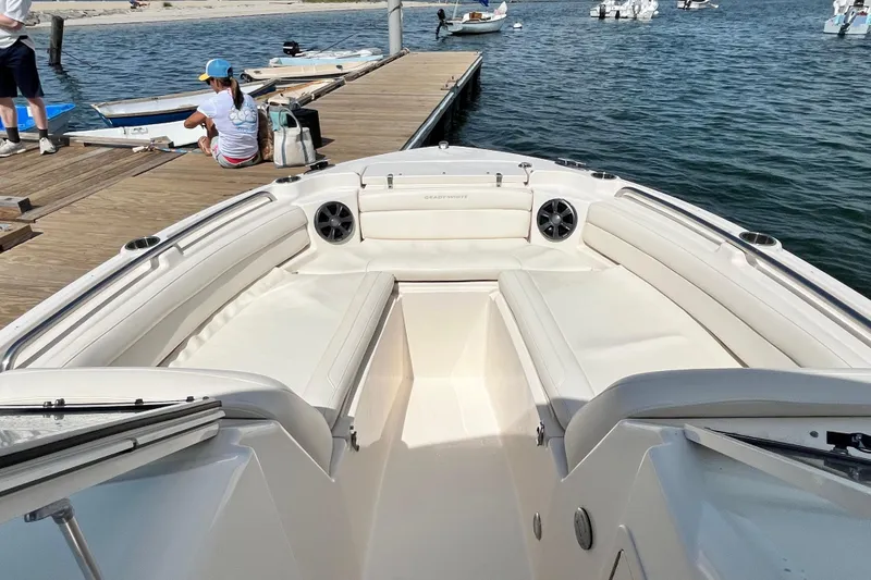Slide: The Image of 2021 Grady-White Freedom 215 boat docked, featuring spacious seating and sleek design. - 23