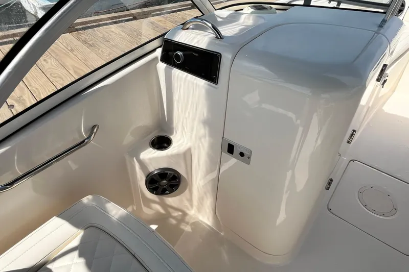 Slide: The Image of Interior of 2021 Grady-White Freedom 215 boat, featuring sleek white design and seating. - 20