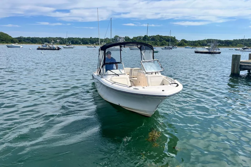 Slide: The Image of 2021 Grady-White Freedom 215 boat cruising on a scenic lake. - 4