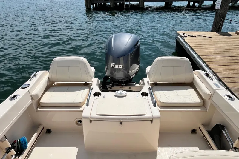 Slide: The Image of 2021 Grady-White Freedom 215 boat with Yamaha 250 engine, docked by the water. - 9