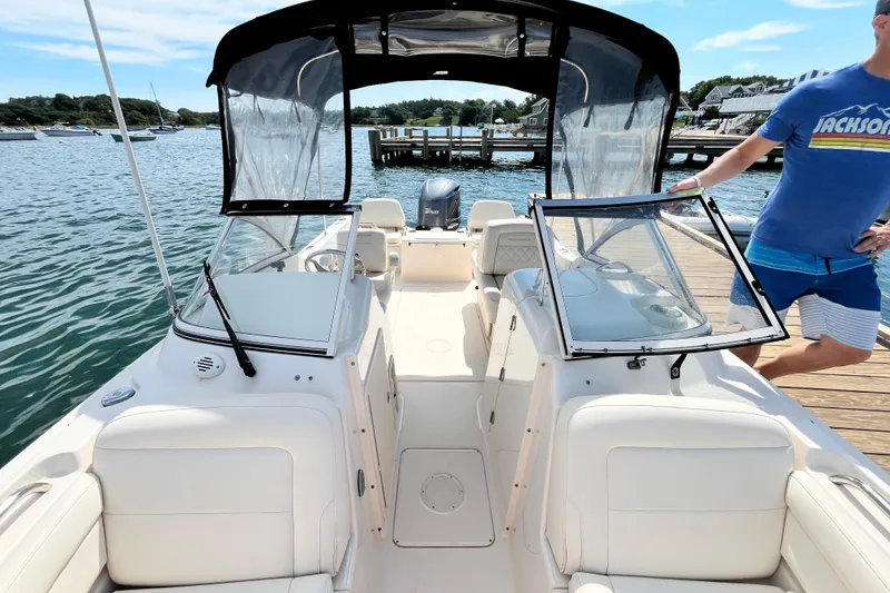 Slide: The Image of 2021 Grady-White Freedom 215 boat docked, featuring open cockpit and seating, with scenic waterfront view. - 29