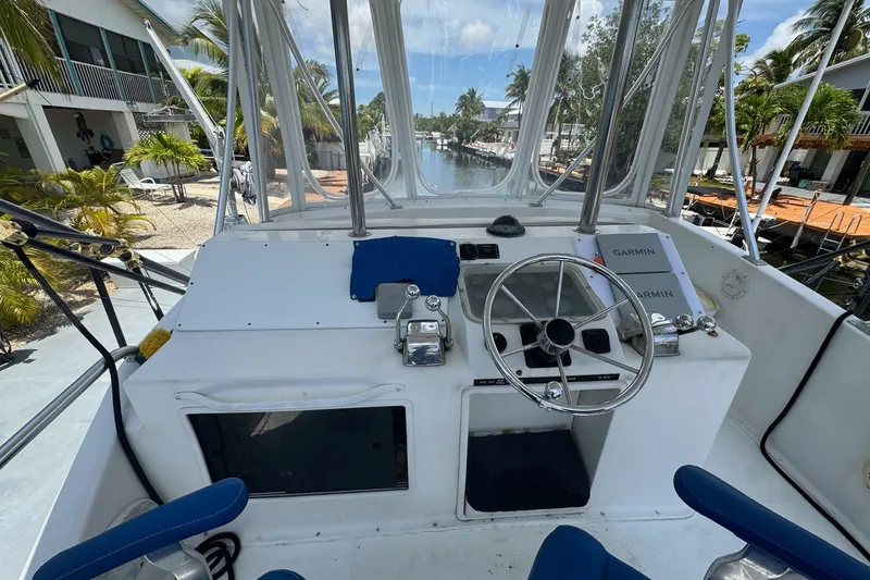 Slide: The Image of Cockpit of 1991 Ocean Yachts 35 Super Sport with steering wheel and navigation equipment. - 16
