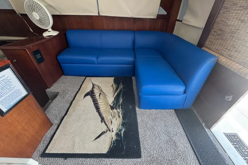 Slide: The Image of Interior of 1991 Ocean Yachts 35 Super Sport with blue sofa and marlin rug. - 35