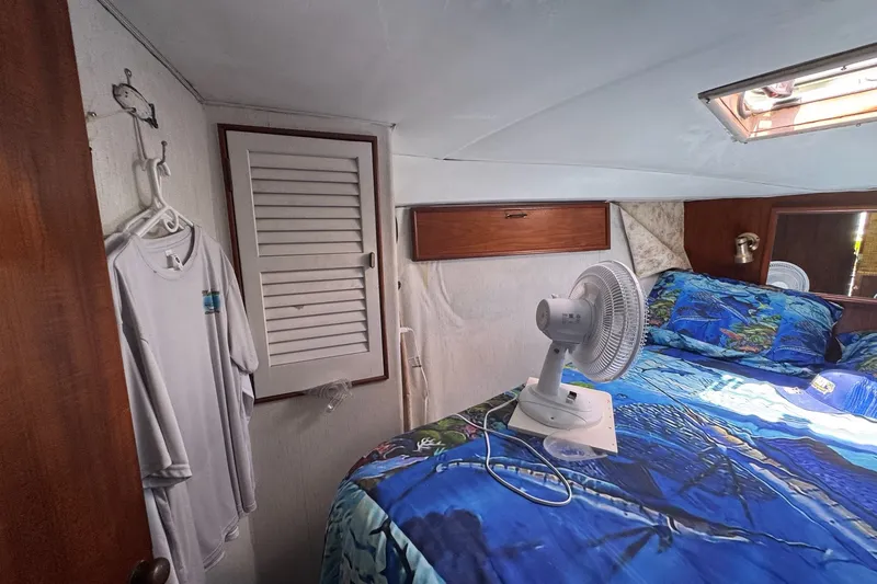 Slide: The Image of Cozy cabin interior of 1991 Ocean Yachts 35 Super Sport with bed and fan. - 58