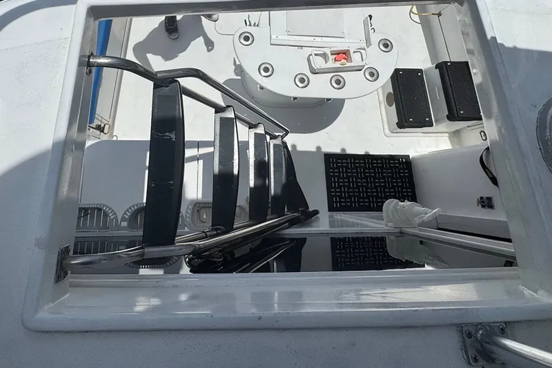 Slide: The Image of View from above of a staircase leading to an open deck with fishing rod holders. - 31