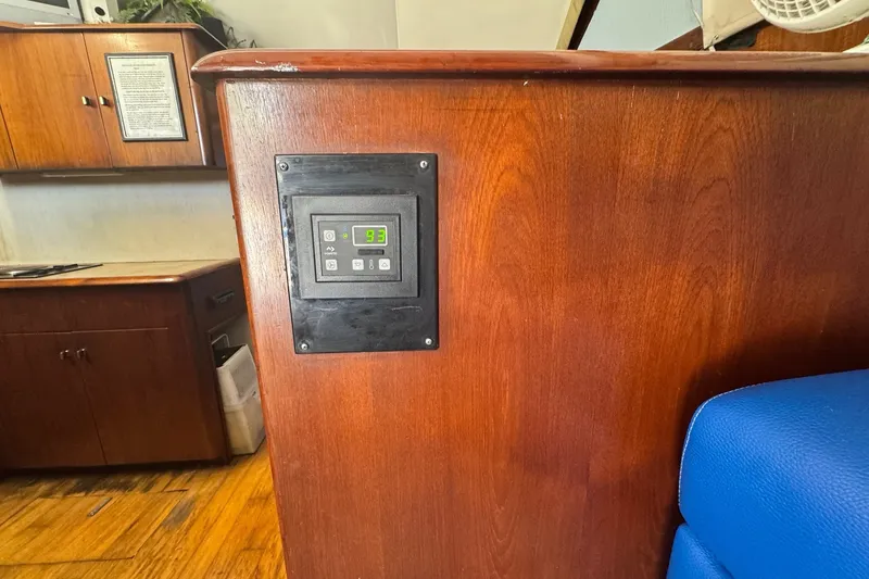 Slide: The Image of Control panel on 1991 Ocean Yachts 35 Super Sport, wooden interior, blue seating. - 37