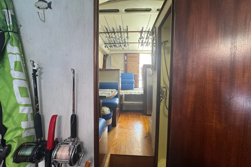 Slide: The Image of Interior view of a 1991 Ocean Yachts 35 Super Sport, featuring fishing rods and seating area. - 61