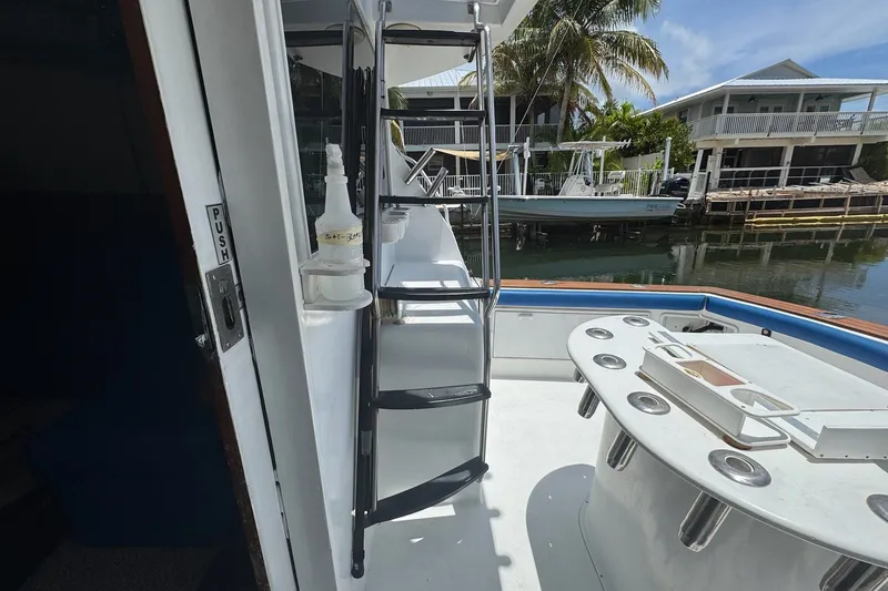 Slide: The Image of 1991 Ocean Yachts 35 Super Sport boat deck with fishing setup and ladder. - 11