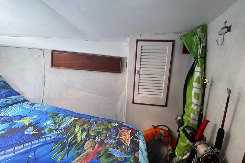 Slide: The Image of Interior of 1991 Ocean Yachts 35 Super Sport with fishing gear and colorful bedding. - 57