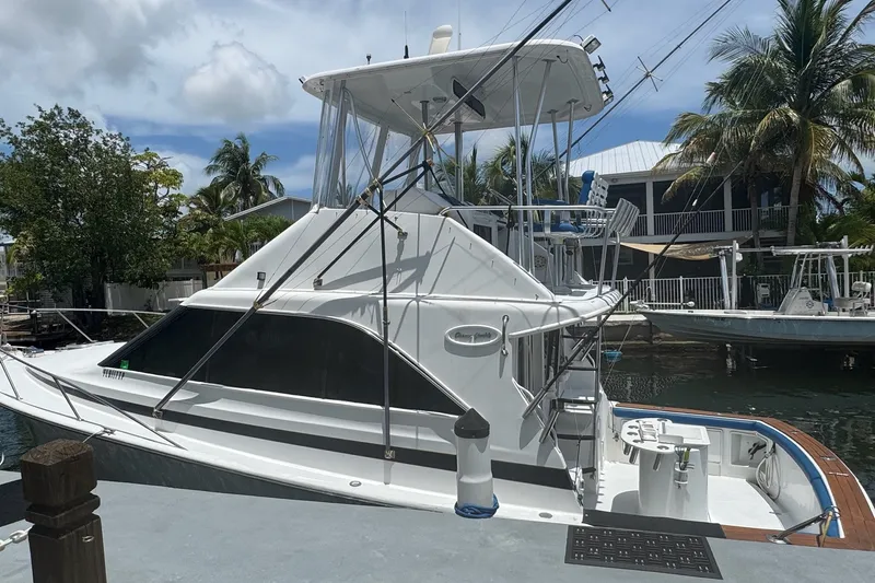 Slide: The Image of 1991 Ocean Yachts 35 Super Sport docked, featuring sleek design and fishing equipment. - 5