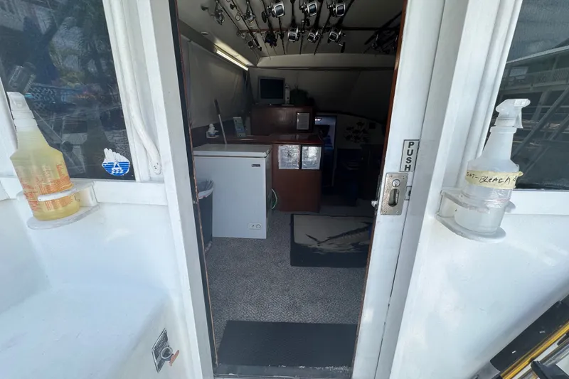 Slide: The Image of Interior view of a 1991 Ocean Yachts 35 Super Sport boat with cleaning supplies. - 32