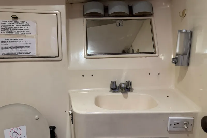 Slide: The Image of Bathroom sink area on a 1991 Ocean Yachts 35 Super Sport boat. - 54