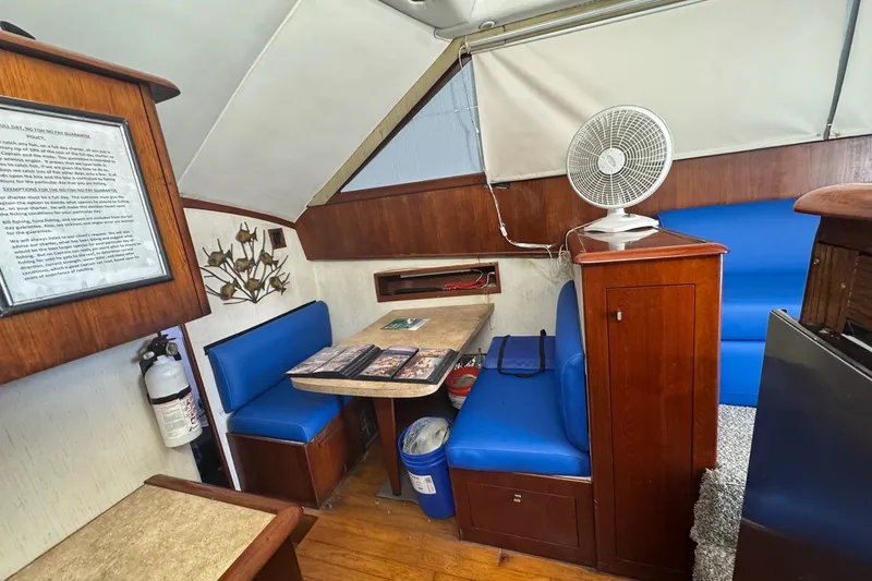 Slide: The Image of Interior of 1991 Ocean Yachts 35 Super Sport with blue seating and wooden accents. - 47
