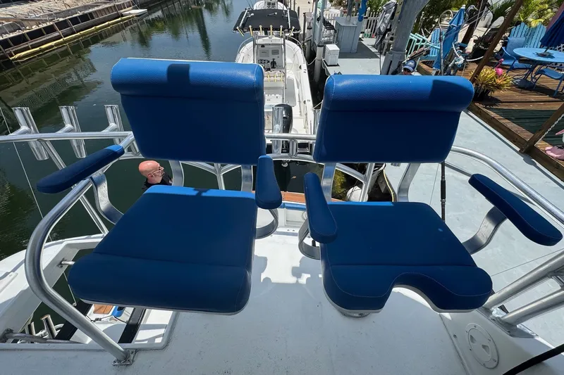 Slide: The Image of Blue captain chairs on a 1991 Ocean Yachts 35 Super Sport boat deck. - 13